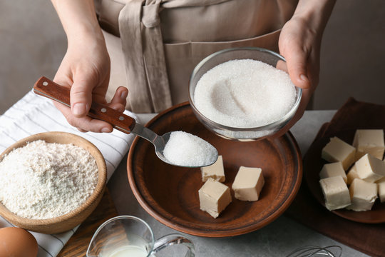 Woman making dough for a pie in bowl