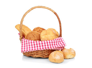 Wicker basket with fresh bread on white background