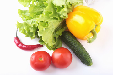 Assorted vegetables, fresh bell pepper, tomato, chilli pepper, cucumber and lettuce isolated on white background. Selective focus.