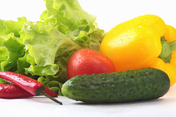 Assorted vegetables, fresh bell pepper, tomato, chilli pepper, cucumber and lettuce isolated on white background. Selective focus.