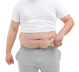 Fat man with measuring caliper on white background, closeup. Weight loss concept