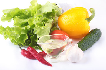 Assorted vegetables, fresh bell pepper, tomato, chilli pepper, cucumber, olive oil, garlic and lettuce isolated on white background. Selective focus.