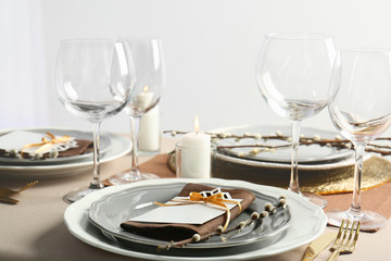 Fototapeta na wymiar Beautiful table setting with golden cutlery