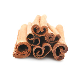 Heap of cinnamon sticks isolated on white, closeup