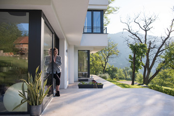 woman in front of her luxury home villa