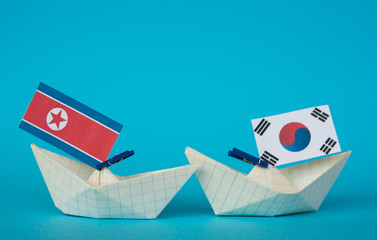 paper ship with Flags of North Korea and South Korea 