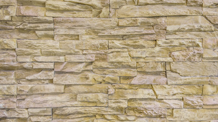 Background of old and dirty vintage rough orange brick stone Cladding wall.