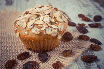Vintage photo, Fresh muffin with oatmeal baked with wholemeal flour and raisins, delicious healthy dessert