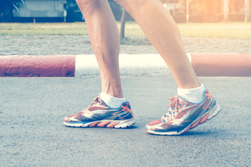 Leg of runner running on the road