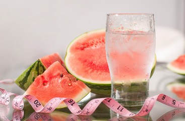 Cup of water and watermelon, diet concept