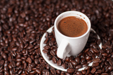 Coffee cup and coffee beans on table