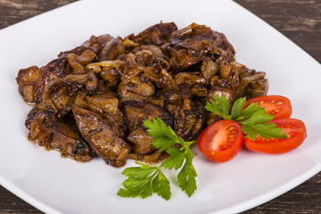 Chicken livers in a creamy sauce with onion on white plate