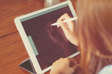 close-up woman hand working with tablet in coffee shop 