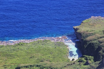 Fototapeta premium Aerial view of Tinian coast Aerial view of a hidden strip of water inlet in the North Field, Tinian, Northern Mariana Islands 