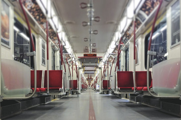 Interior of empty subway car with bright red seats - obrazy, fototapety, plakaty