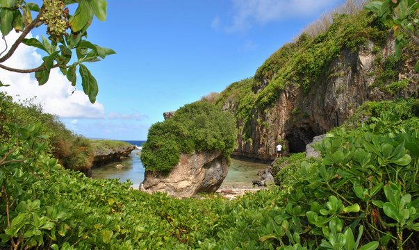 Hidden cove and water inlet, Tinian A hidden cove and water inlet that fills up during high tide in the North Field of Tinian, Northern Mariana Islands.