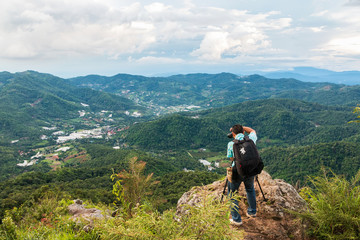 Fototapeta na wymiar A man taking photo at Mon Long Mon Cham (Mon Jam) mountain, Mae Rim Chiangmai