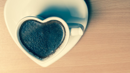 Coffee in heart shaped cup mug. Caffeine energy.