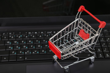 Shopping basket on a laptop. Concept of shopping online.