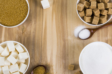 Different kind of white and brown sugar on old brown table