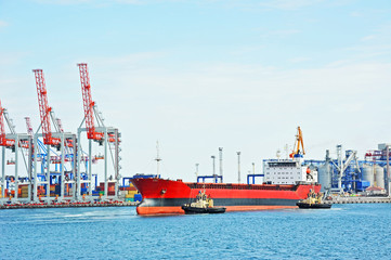 Tugboat assisting bulk cargo ship