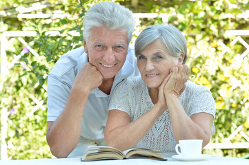 Mature couple at a table with a book 