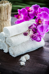 Obraz na płótnie Canvas Accessories for spa. White towels, orchid and stones for spa