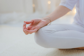Yoga woman meditating and making a zen symbol with her hand