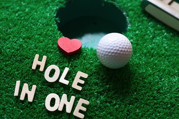 Hole in one on green grass