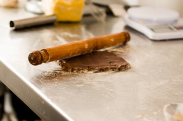 Bakery man cutting delicious christmas chocolate cookies in a bakery store