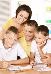 Obraz na płótnie Canvas Happy parents with children at home