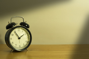 Alarm clock on wood table.