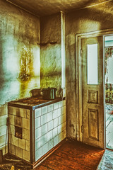kitchen and a stove in the old poor dark apartment. Noise and grain are added deliberately by a special filter
