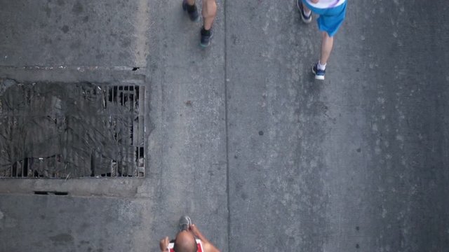 Slow motion people of runners at marathon race on street, top view