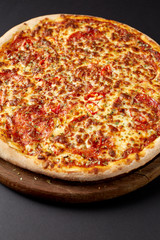 Hot pizza on a rustic wooden table.