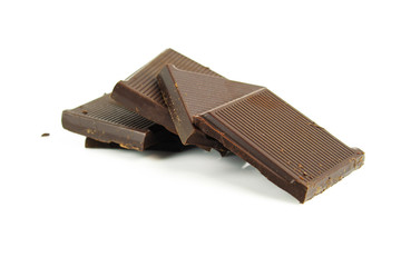Chocolate cream and chocolate pieces on white background