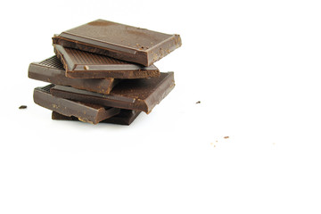 Chocolate cream and chocolate pieces on white background