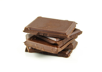 Chocolate cream and chocolate pieces on white background