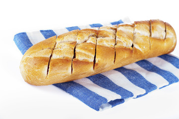 Fresh bread on towel, white background