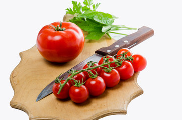 Tomato and knife on the cutting board. Isolated