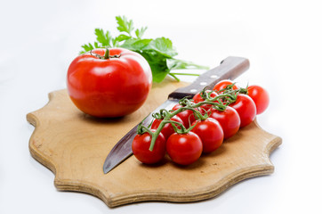 Tomato and knife on the cutting board. Isolated