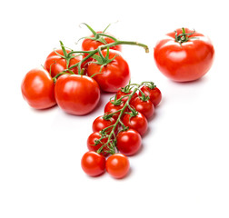 Composition of small cherry and large tomato. Isolated