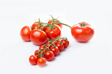 Composition of small cherry and large tomato. Isolated