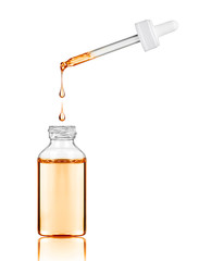 Cosmetic bottle with pipette on white background