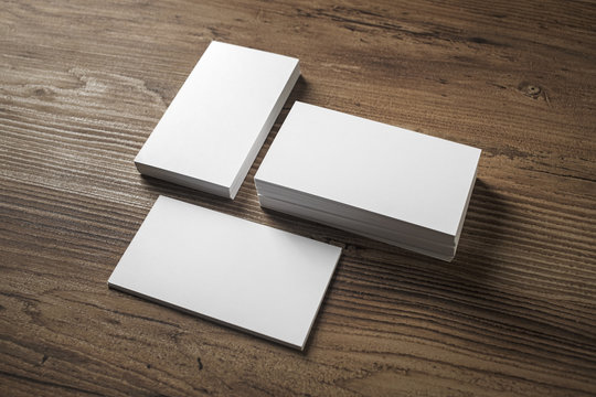Photo of blank white business cards on wooden background. For design presentations and portfolios.