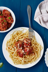 Spaghetti pasta with meatballs, tomato sauce, grated parmesan cheese . healthy homemade italian pasta. Top view