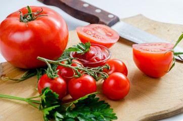 Tomato and knife on the cutting board. Isolated