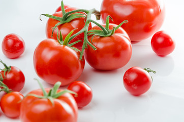 Composition of small cherry and large tomato. Isolated