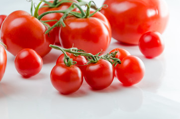 Composition of small cherry and large tomato. Isolated