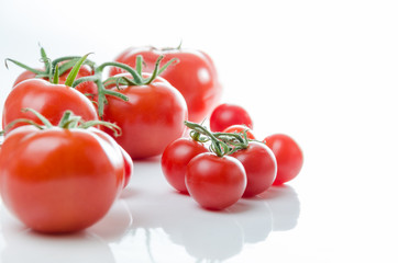 Composition of small cherry and large tomato. Isolated
